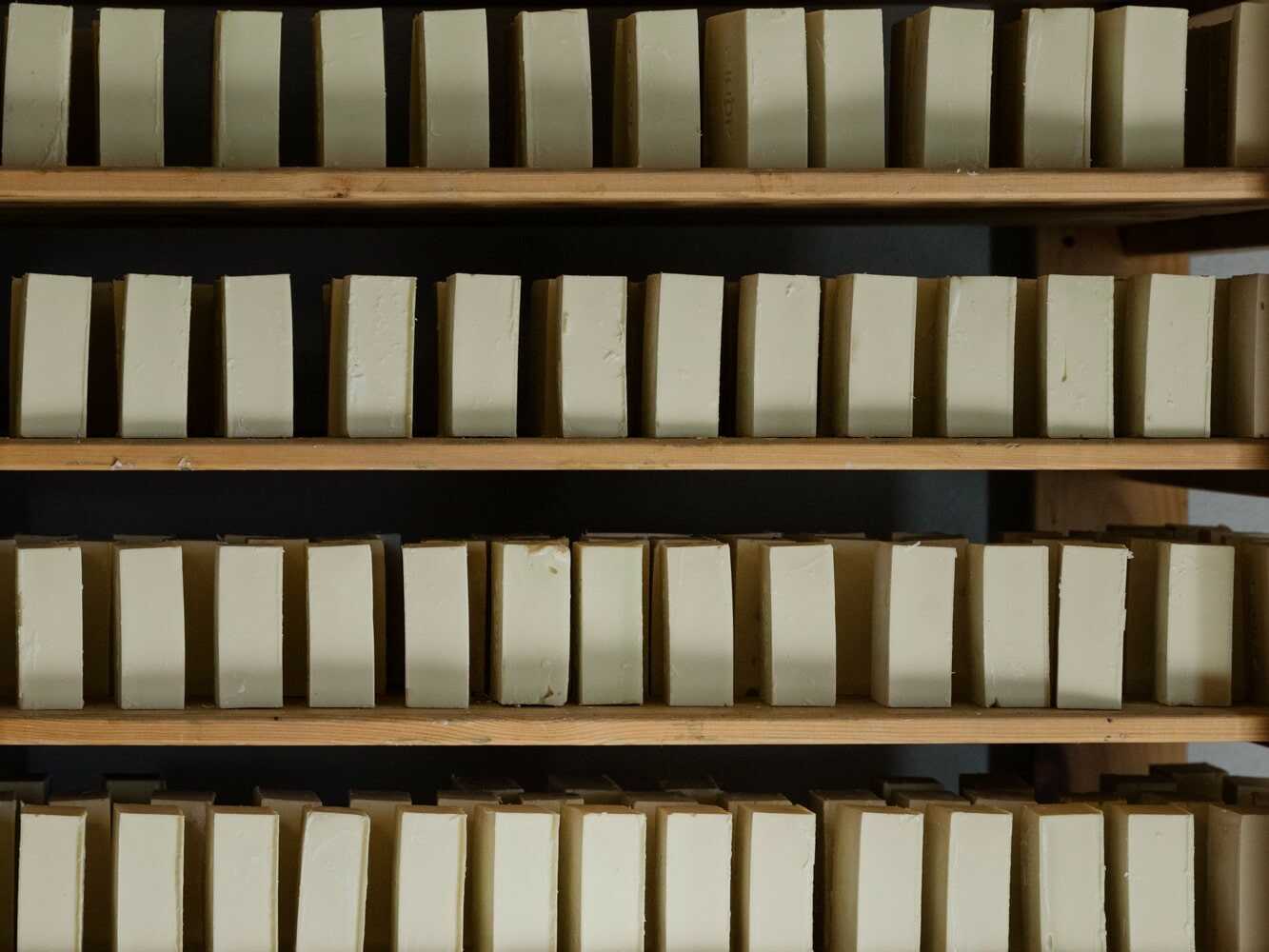 Finished Soaperb soaps drying on racks